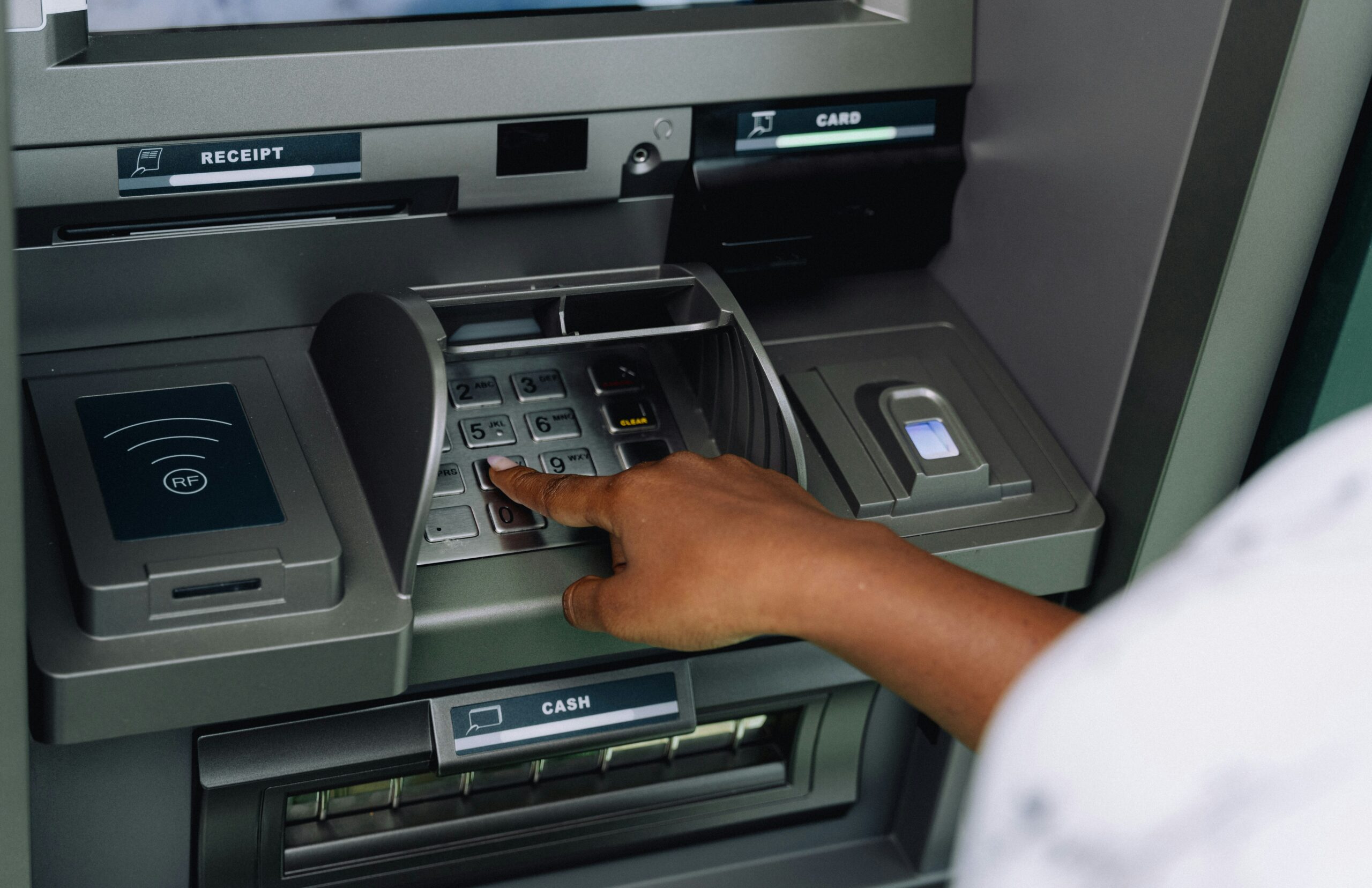 Person using an ATM to withdraw cash after cashing a check